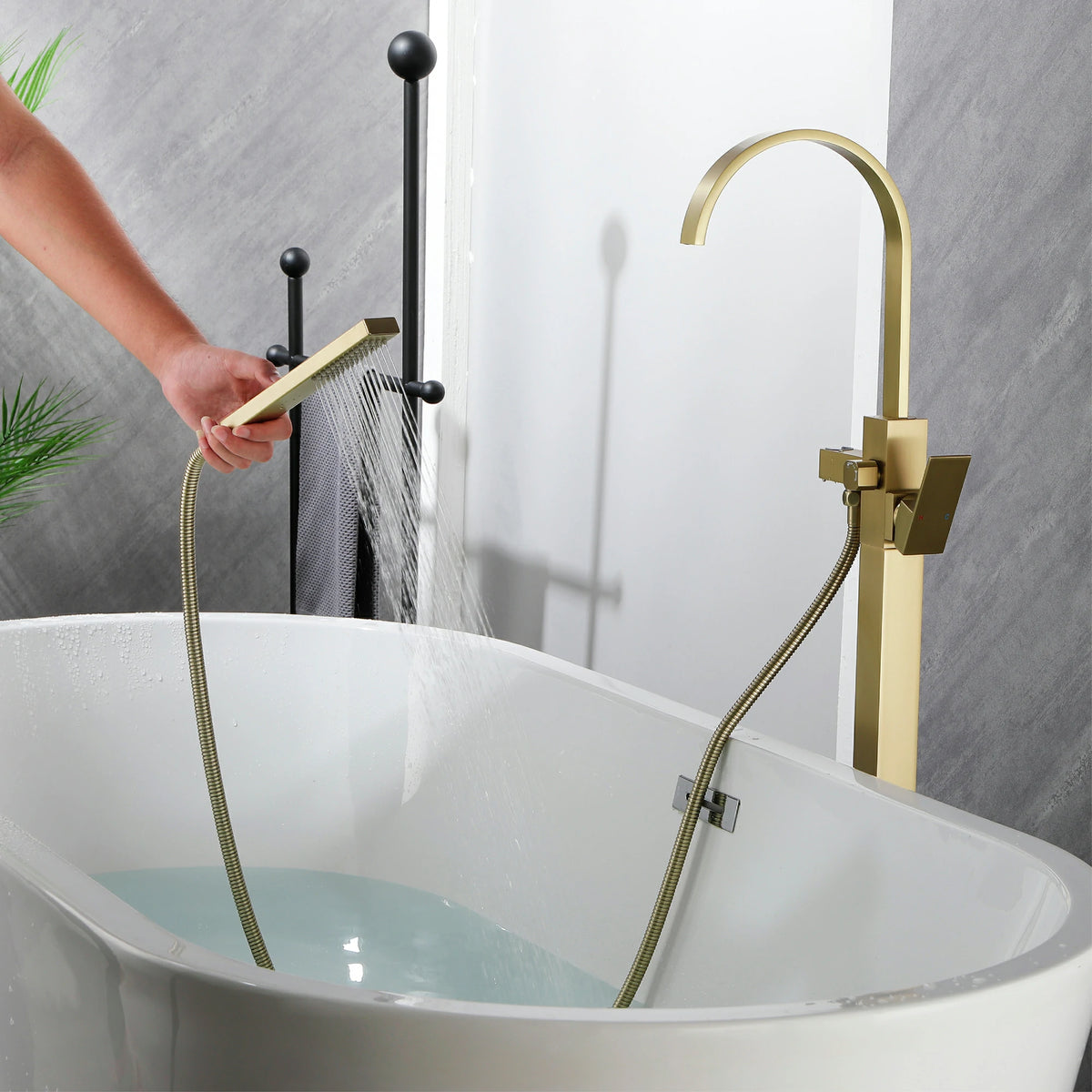 360° Swivel Waterfall Freestanding Bathtub Faucet with Hand Shower in Brushed Gold