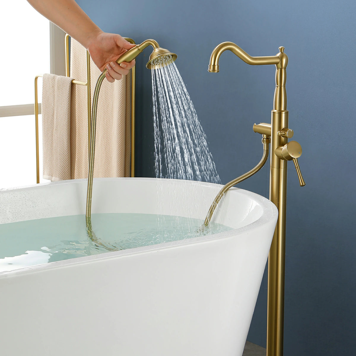 360° Swivel Waterfall Freestanding Bathtub Faucet with Hand Shower in Brushed Gold