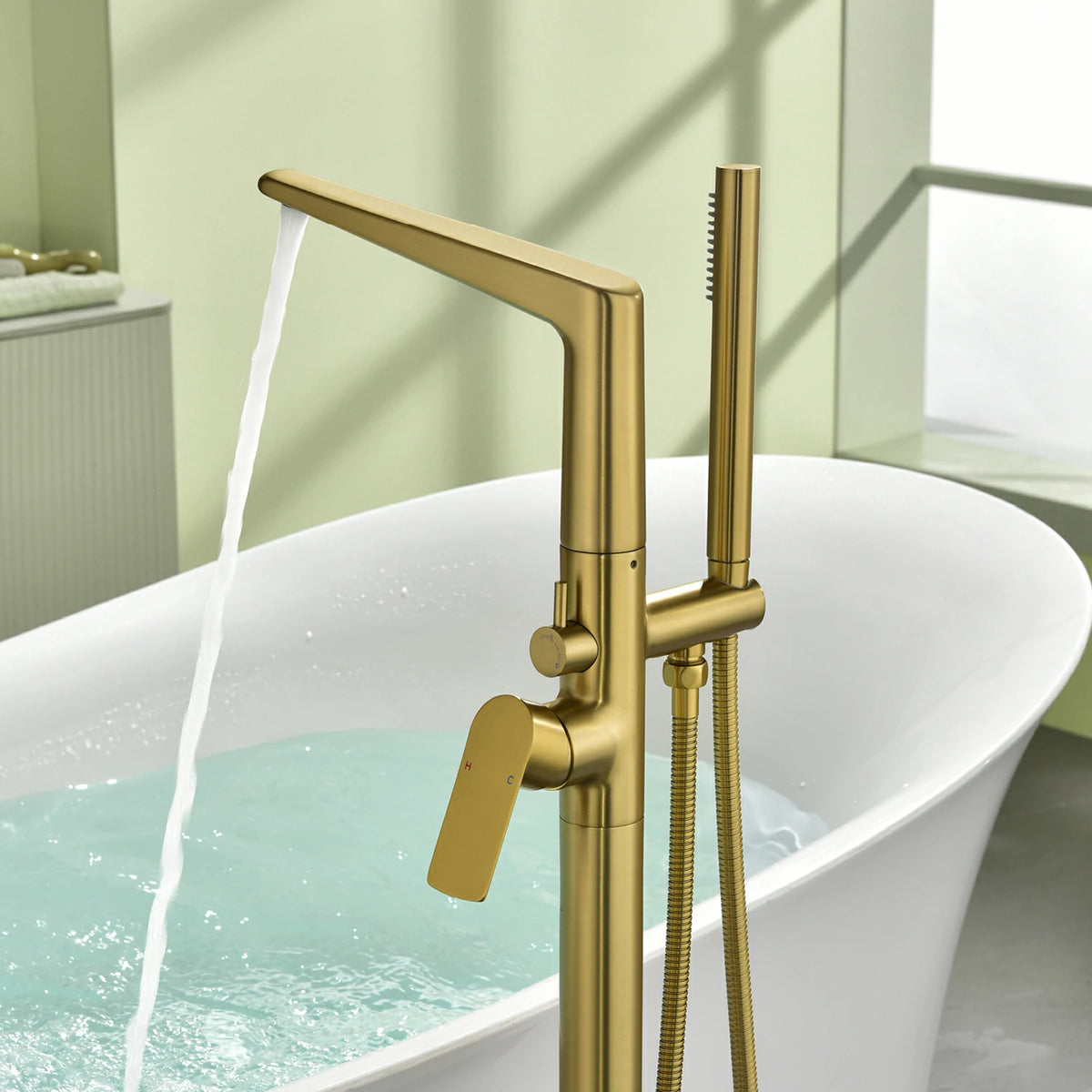 One-Piece Brass Waterfall Freestanding Bathtub Faucet with Hand Shower in Brushed Gold