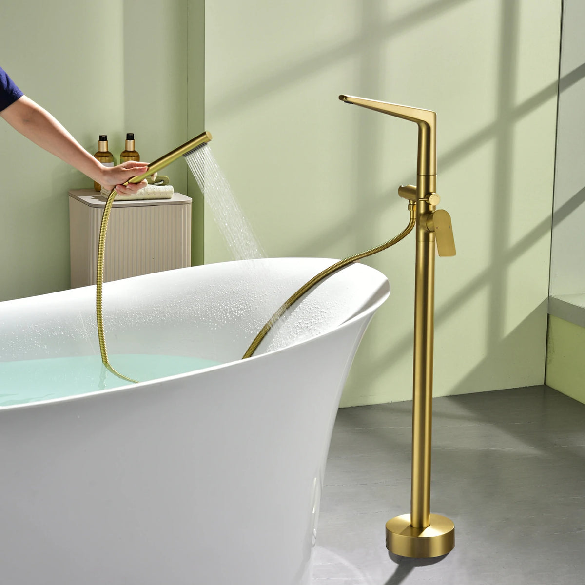 One-Piece Brass Waterfall Freestanding Bathtub Faucet with Hand Shower in Brushed Gold